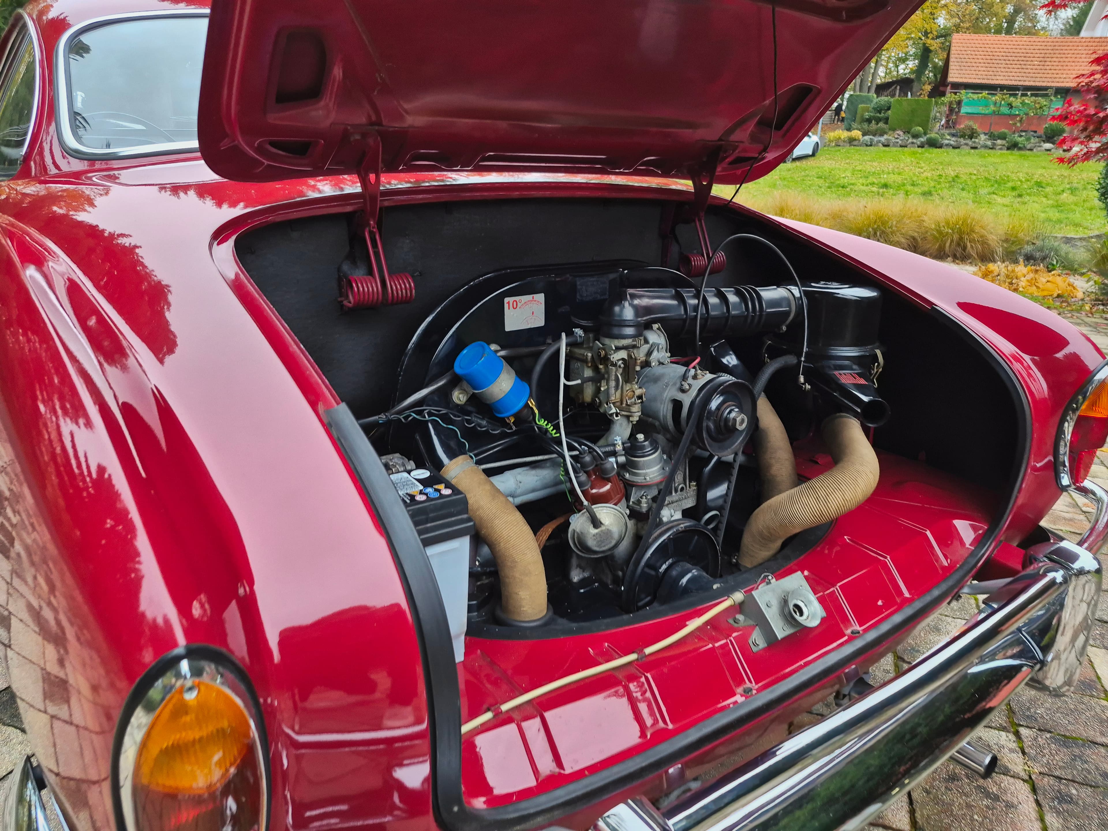 Stunning VW Karmann Ghia Coupe in cherry red with original equipment.