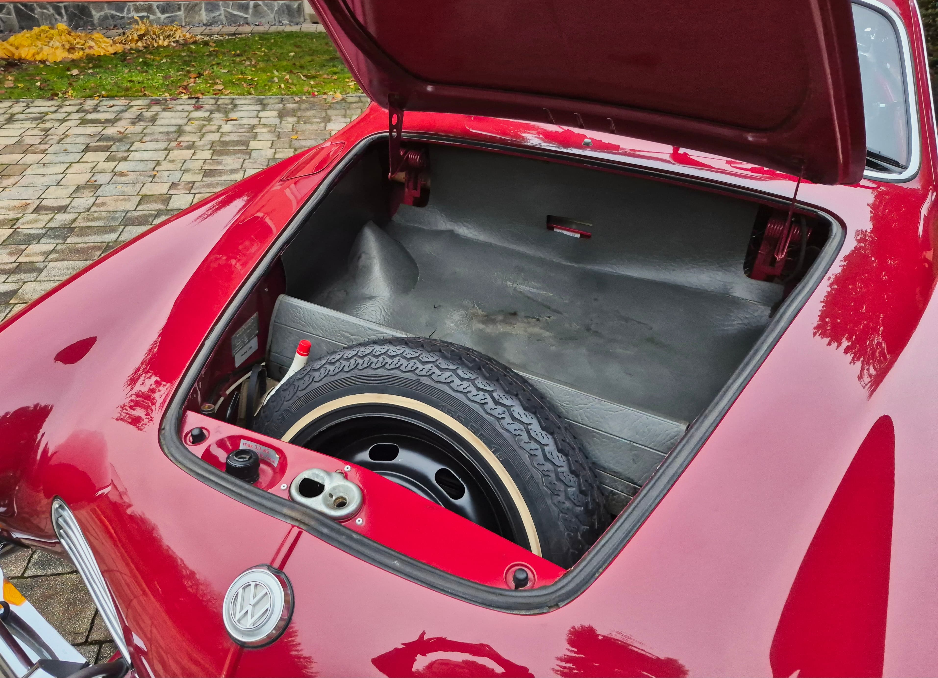 Stunning VW Karmann Ghia Coupe in cherry red with original equipment.